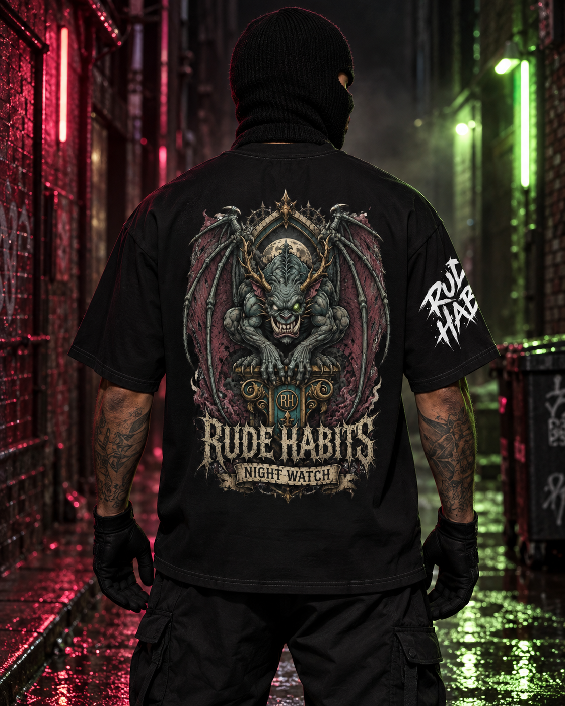 A man wearing a black balaclava and a black graphic t-shirt stands in a dark, neon-lit alleyway, viewed from behind. The t-shirt features a large, detailed gothic dragon graphic on the back with the text 'RUDE HABITS NIGHT WATCH' and a white 'RUDE HABITS' logo on the sleeve.