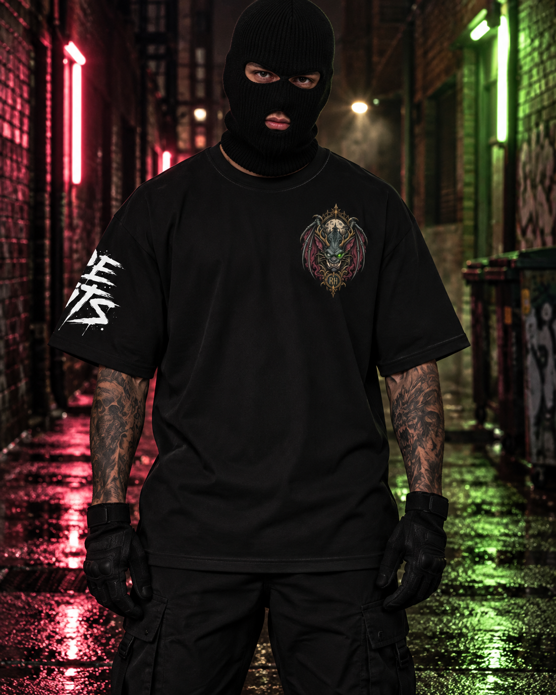 A person wearing a black balaclava, black graphic t-shirt, and black cargo pants stands in a wet, neon-lit alleyway at night.