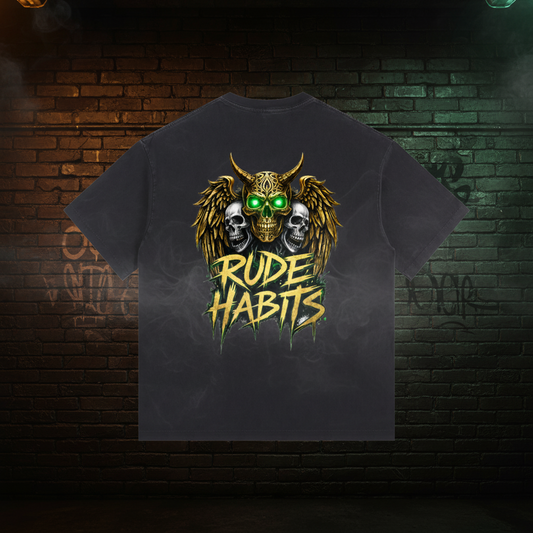 A black short-sleeve t-shirt with a large graphic print on the back. The graphic features a horned skull with glowing green eyes, three skulls behind it, and the text 'RUDE HABITS' in a dripping yellow font.